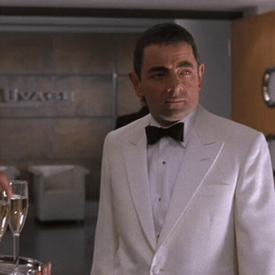 Man In White Tuxedo And Bow Tie With Ivangard Sign GIF