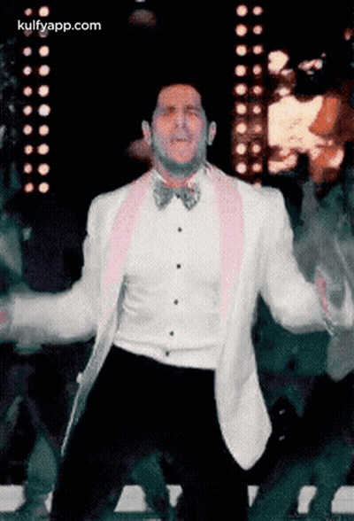 Man In White Tuxedo And Pink Bow Tie Dancing GIF