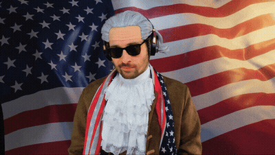Man In Wig And Headphones Before American Flag GIF