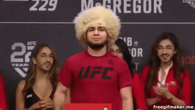 Man In Wig And Red Shirt In Front Of Crowd GIF