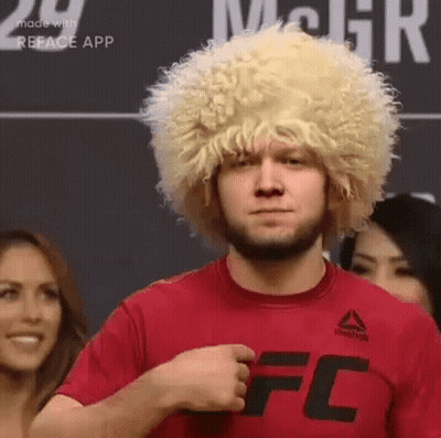 Man In Wig And Red T-Shirt In Front Of Crowd GIF