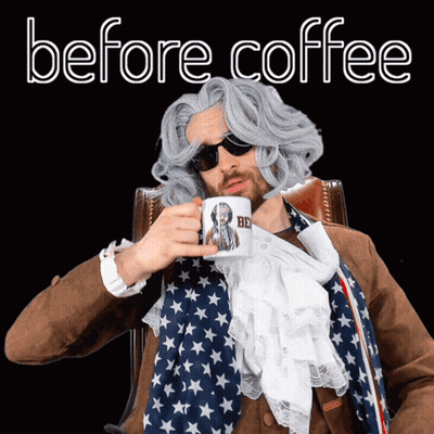 Man In Wig And Sunglasses Holding Coffee Mug Saying Be GIF