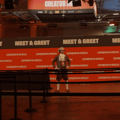 Man In Wig And Sunglasses In Front Of Dreamhack Sign GIF