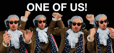 Man In Wig And Sunglasses In Front Of One Of Us Sign GIF