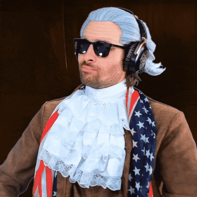 Man In Wig And Sunglasses With Headphones And American Flag Scarf GIF