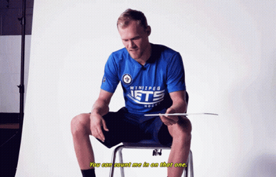 Man In Winnipeg Jets Shirt Sitting On Chair GIF