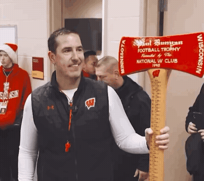 Man In Wisconsin Vest Holding Football Trophy GIF
