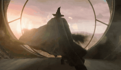 Man In Witch Hat In Front Of Large Window GIF