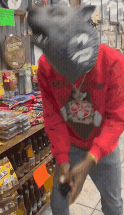 Man In Wolf Mask Standing In Front Of Bottles GIF