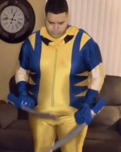Man In Wolverine Costume Holding Vacuum Cleaner GIF