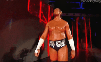 Man In Wrestling Outfit Before Crowd In Dark Room GIF