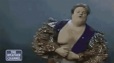 Man In Wrestling Outfit Standing On Stage GIF