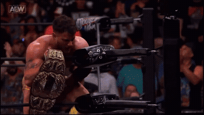 Man In Wrestling Ring Holding AEW Belt GIF