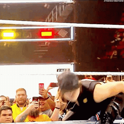 Man in Wrestling Ring Holding Free Sign