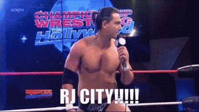 Man In Wrestling Ring Holding Microphone Saying RJ City GIF