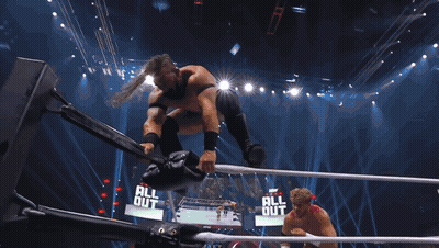 Man In Wrestling Ring Holding TNT Microphone GIF