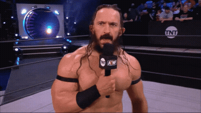 Man In Wrestling Ring Holding TNT Microphone GIF