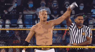 Man In Wrestling Ring Holding Up Arm In Front Of Referee GIF