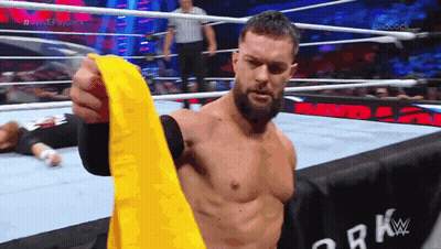 Man In Wrestling Ring Holding Yellow Belt GIF