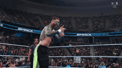 Man In Wrestling Ring Wearing Sunglasses Saying N & E GIF