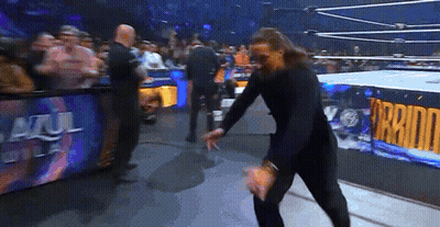 Man In Wrestling Ring With Azul Del Sol Sign GIF