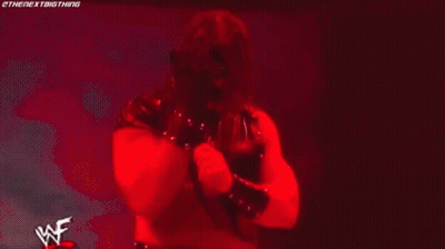 Man In Wrestling Ring With Flame Saying Wrestle GIF