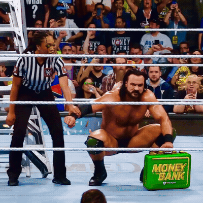 Man In Wrestling Ring With Green Money Bank GIF
