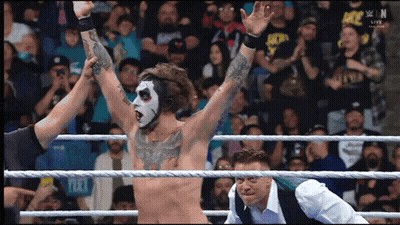 Man In Wrestling Ring With Hands In Air GIF