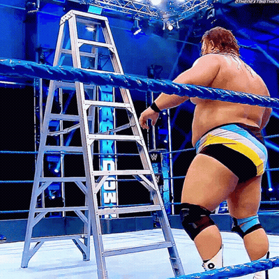 Man In Wrestling Ring With Ladder In Front Of Raw Sign GIF