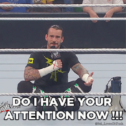 Man In Wrestling Ring With Microphone Says Do I Have Your Attention Now GIF