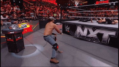 Man In Wrestling Ring With NXT Sign GIF