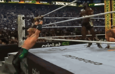 Man In Wrestling Ring With Royal Rumble Ad GIF