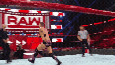 Man In Wrestling Ring With Sign Saying Raw GIF
