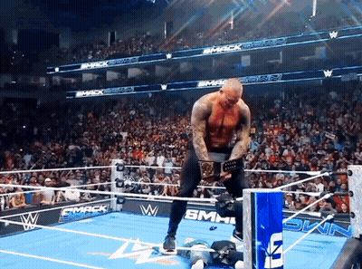 Man In Wrestling Ring With Smack Down Sign GIF