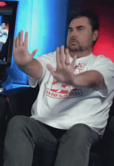 Man In Wrestling Shirt Holding Hands Up GIF