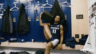 Man In Xavier Jersey Sitting GIF
