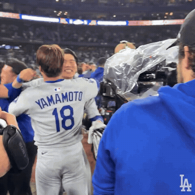 Man In Yamamoto 18 Jersey Hugging Another Man GIF