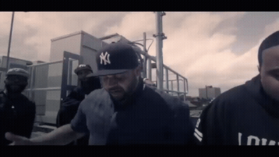 Man In Yankees Hat Led By Police Officer GIF