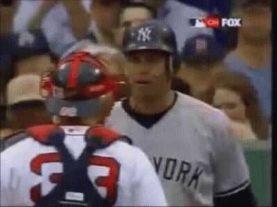 Man in Yankees Jersey Talking to Another Man