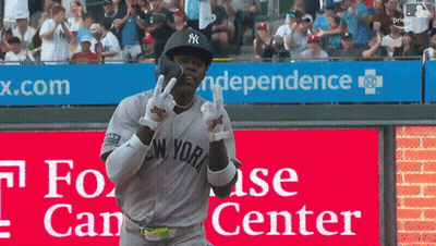 Man In Yankees Uniform In Front Of Independence Sign GIF