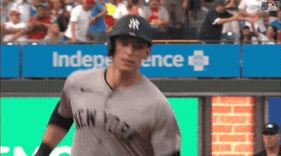Man In Yankees Uniform In Front Of Independence Sign GIF