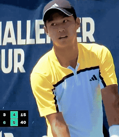 Man In Yellow Adidas Shirt Playing Tennis In Front Of Halle Ur Banner GIF