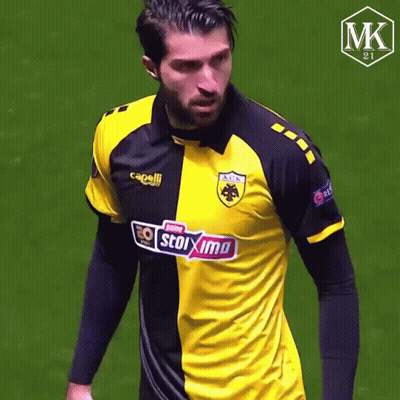 Man In Yellow And Black Stoixima Shirt GIF