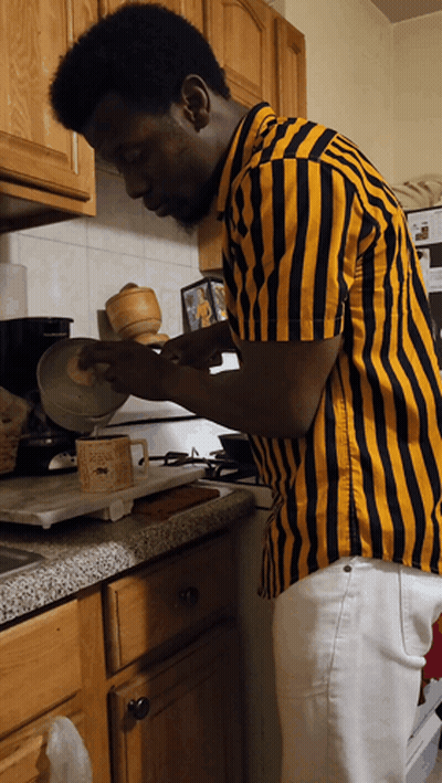 Man in Yellow and Black Striped Shirt Cooking