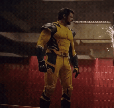 Man In Yellow And Black Superhero Suit Facing Fire GIF