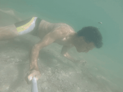 Man In Yellow And Black Swimsuit Swimming GIF