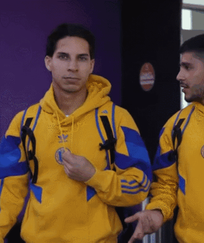 Man in Yellow and Blue Adidas Sweatshirt