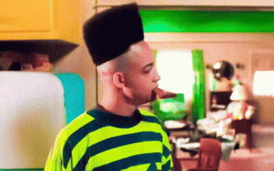 Man In Yellow And Blue Striped Shirt With High Hair GIF