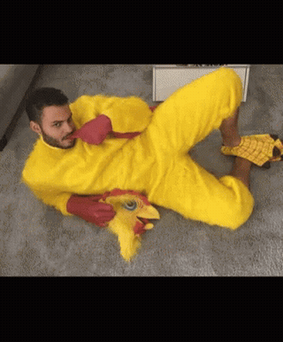 Man In Yellow Chicken Costume Lying Down GIF