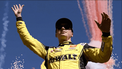 Man In Yellow DeWalt Jacket In Front Of Fireworks GIF